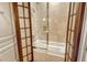 Bathroom with a bathtub and shower behind shoji screens at 2151 Gulf Of Mexico Dr # 5, Longboat Key, FL 34228