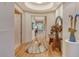 Long hallway with hardwood floors, decorative accents, and access to bedrooms at 2151 Gulf Of Mexico Dr # 5, Longboat Key, FL 34228