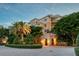 Elegant building exterior with landscaped grounds and palm trees at 2151 Gulf Of Mexico Dr # 5, Longboat Key, FL 34228