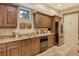 Well-equipped kitchen with wood cabinets, granite countertops, and modern appliances at 2151 Gulf Of Mexico Dr # 5, Longboat Key, FL 34228