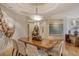 Elegant dining room with hardwood floors, modern light fixture and statement art at 2151 Gulf Of Mexico Dr # 5, Longboat Key, FL 34228