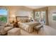 Spacious main bedroom with sitting area and balcony access at 2151 Gulf Of Mexico Dr # 5, Longboat Key, FL 34228