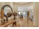 Bright entryway with hardwood floors, large mirror, and views to other rooms at 2151 Gulf Of Mexico Dr # 5, Longboat Key, FL 34228