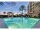 Stunning pool at sunset with building in the background, offering a relaxing retreat at 2151 Gulf Of Mexico Dr # 5, Longboat Key, FL 34228