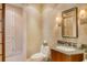 Powder room with granite vanity and decorative wallpaper at 2151 Gulf Of Mexico Dr # 5, Longboat Key, FL 34228