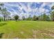 Spacious backyard with lush green grass and a large home at 3125 Pickett St, Port Charlotte, FL 33981