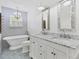 Charming bathroom with a clawfoot tub, double vanity, and patterned floor tiles at 3125 Pickett St, Port Charlotte, FL 33981