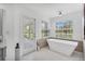 Spa-like bathroom featuring a freestanding soaking tub and private access to the backyard at 3125 Pickett St, Port Charlotte, FL 33981