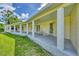 Long back porch with columns and rocking chairs, providing ample outdoor space at 3125 Pickett St, Port Charlotte, FL 33981