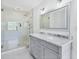 Elegant bathroom featuring a double vanity and a large walk-in shower at 3125 Pickett St, Port Charlotte, FL 33981