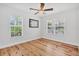 Spacious bedroom with hardwood floors, large windows, and ceiling fan at 3125 Pickett St, Port Charlotte, FL 33981