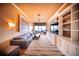 Spacious Gathering room with built-in shelving, a large sectional sofa, and water views at 1111 Ritz Carlton Dr # 1802, Sarasota, FL 34236