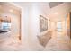 Bright hallway with marble floors and large framed artwork on the walls at 1111 Ritz Carlton Dr # 1802, Sarasota, FL 34236
