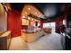 Home office with a large desk, built-in cabinetry, and red walls at 1111 Ritz Carlton Dr # 1802, Sarasota, FL 34236