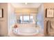 Luxurious bathroom with a large soaking tub and water views at 1111 Ritz Carlton Dr # 1802, Sarasota, FL 34236