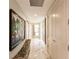 Long hallway with marble floors, artwork, and a built-in bench at 1111 Ritz Carlton Dr # 1802, Sarasota, FL 34236
