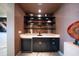 Modern wet bar with dark cabinetry, marble countertops, and floating shelves at 1111 Ritz Carlton Dr # 1802, Sarasota, FL 34236