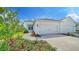 Two-car garage and walkway to the front entrance of a house at 14631 Barefoot Ln, Parrish, FL 34219