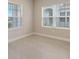 Bright bedroom with two large windows and tile floors at 14631 Barefoot Ln, Parrish, FL 34219