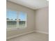 Bright bedroom with large window and tile flooring at 14631 Barefoot Ln, Parrish, FL 34219