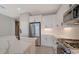 Modern kitchen with stainless steel appliances and white cabinets at 14631 Barefoot Ln, Parrish, FL 34219