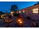 Cozy fire pit area in the backyard at night at 301 Aurora E St, Venice, FL 34285