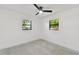 Spacious bedroom with two windows and ceiling fan at 301 Aurora E St, Venice, FL 34285