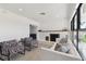Living room includes a white sofa, fireplace, and patterned armchairs at 301 Aurora E St, Venice, FL 34285