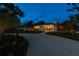Modern home with attractive landscaping at night at 301 Aurora E St, Venice, FL 34285