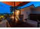 Evening view of patio furniture under an umbrella at 301 Aurora E St, Venice, FL 34285
