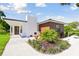 Modern home with white and wood exterior, stone patio at 301 Aurora E St, Venice, FL 34285