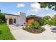 Modern home with white and wood exterior, stone patio at 301 Aurora E St, Venice, FL 34285