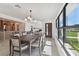 Bright dining room features a large table, modern light fixture, and open concept floor plan at 301 Aurora E St, Venice, FL 34285
