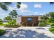 Modern home with a wood exterior and a landscaped yard at 301 Aurora E St, Venice, FL 34285