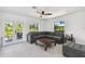 Gathering room boasts a sectional sofa and ample natural light from large windows at 301 Aurora E St, Venice, FL 34285