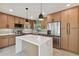 Open concept kitchen with island, stainless steel appliances, and light wood cabinets at 301 Aurora E St, Venice, FL 34285