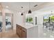 Open concept kitchen with island and views into dining area at 301 Aurora E St, Venice, FL 34285