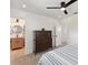 Spacious bedroom with a dresser, ceiling fan, and striped bedding at 301 Aurora E St, Venice, FL 34285