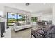 Living room features a white sofa, fireplace, and large windows with a view of the street at 301 Aurora E St, Venice, FL 34285