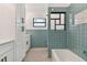 Stylish bathroom with updated white cabinets and blue tile at 301 Aurora E St, Venice, FL 34285