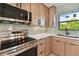 Stainless steel kitchen appliances, including a gas range and microwave at 301 Aurora E St, Venice, FL 34285