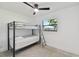 Well-lit bedroom featuring a bunk bed, ceiling fan, and window at 301 Aurora E St, Venice, FL 34285