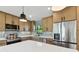 Modern kitchen with large island, stainless steel appliances, and light wood cabinets at 301 Aurora E St, Venice, FL 34285