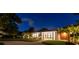 Modern single-story home with a landscaped yard at night at 301 Aurora E St, Venice, FL 34285
