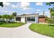 Newly renovated home with a white exterior and a landscaped yard at 301 Aurora E St, Venice, FL 34285