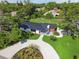 Aerial view of a remodeled home with a circular driveway and manicured landscaping at 301 Aurora E St, Venice, FL 34285