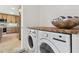Laundry room with side-by-side washer and dryer and wood countertop at 301 Aurora E St, Venice, FL 34285