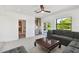 Bright Gathering room features a comfortable sectional sofa, large windows, and a view of the backyard at 301 Aurora E St, Venice, FL 34285