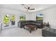 Gathering room with sectional sofa, coffee table, and access to backyard through sliding glass doors at 301 Aurora E St, Venice, FL 34285