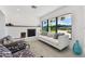 Living room with white sofa, fireplace, and patterned armchairs at 301 Aurora E St, Venice, FL 34285